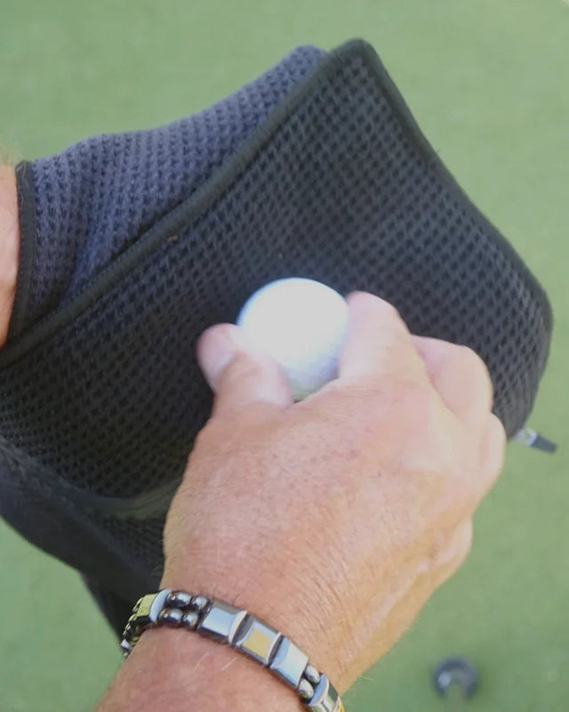Cleaning a golf ball with the towel