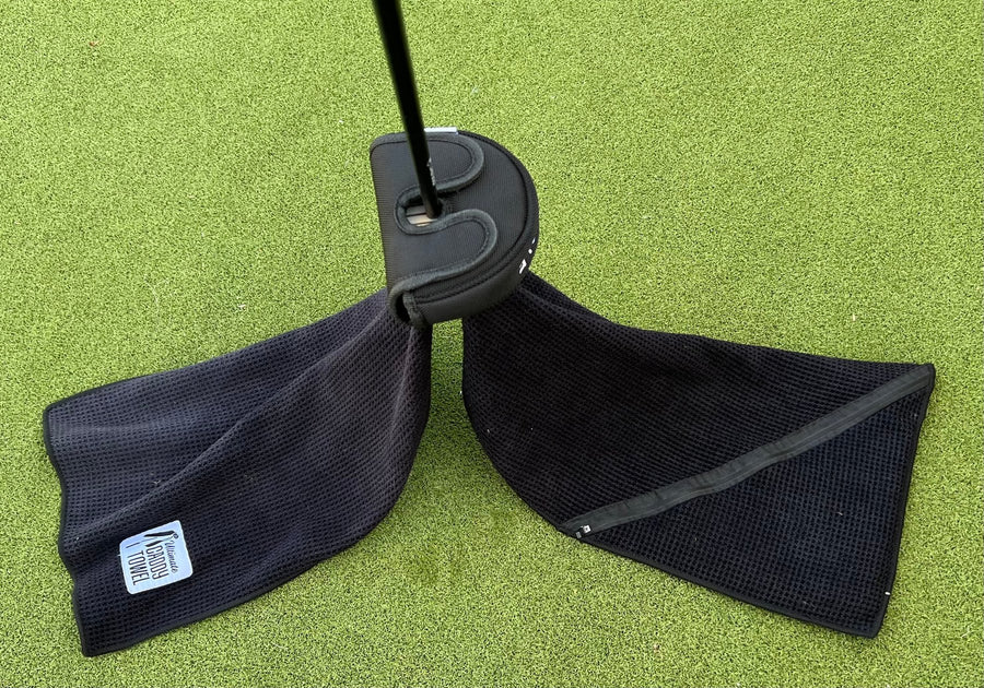 The towel draped over a putter on the green