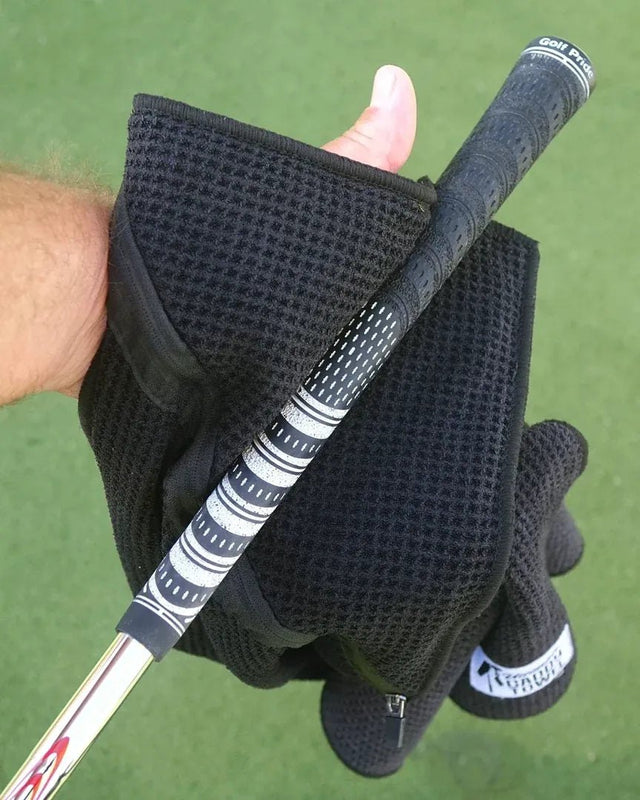Wiping a golf grip with the towel