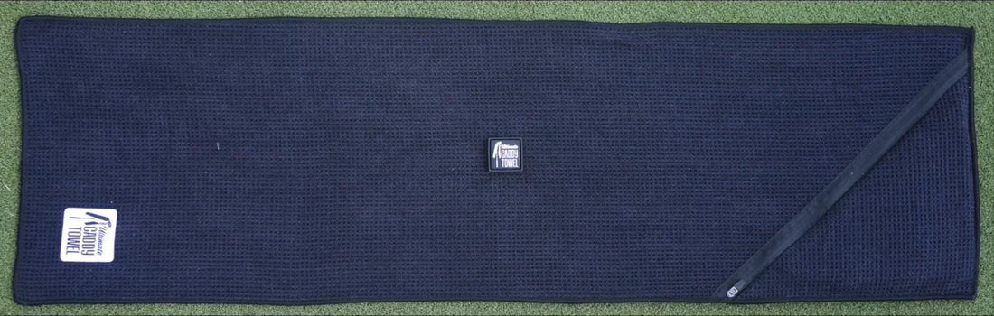 The Ultimate Caddy Towel laid flat, showing the center magnet and the zipped sponge pocket